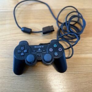 black Sony DUALSHOCK 2 wired controller for the PlayStation 2 console
